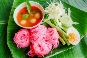 rice noodle colorful pink or rice vermicelli noodle and fish curry soup sauce with vegetable