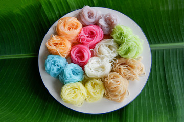 Food thai noodle vermicelli / colorful rice noodle vermicelli on white plate on banana leaf background