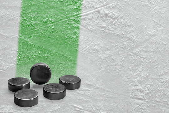 Pucks and ice arena fragment with green line