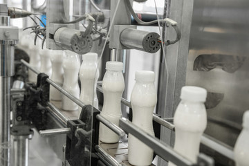 plastic milk bottles on conveyor belt. equipment at the dairy plant