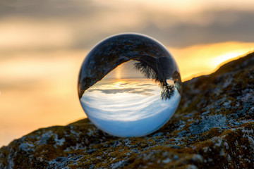  Upside down sunset landscape at Cape Kaliakra, Bulgaria, Eastern Europe - reflection in a lensball - selective focus, space for text