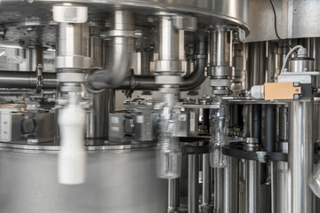 filling milk in to plastic bottles at the factory. equipment at the dairy plant