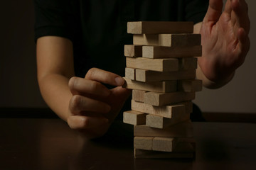 Hand of woman planning, risk and strategy in business.Businessman gambling placing wooden block on...