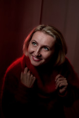 Portrait of a middle-aged woman in the room. Photography in the Studio. Photo shoot in a dark key