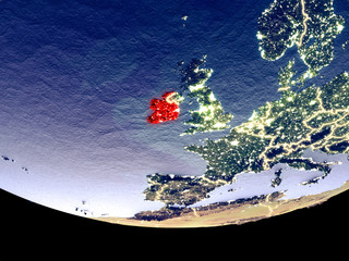 Satellite view of Ireland from space at night. Beautifully detailed plastic planet surface with visible city lights.