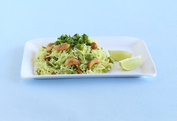 Rice noodles, a healthy and spicy south Indian vegetarian steam-cooked food, on a ceramic tray.