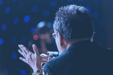 Speaker giving a talk on corporate Business Conference hall or seminar room background.