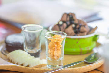 The background of the chocolate ice cream, decorated with colorful cups, modern and traditional design together, is a menu for customers to choose and take pictures before eating
