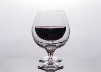 isolate two drinking glass  with red wine one after the other on black background