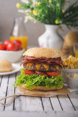 Homemade bacon burger with lettuce and cheddar