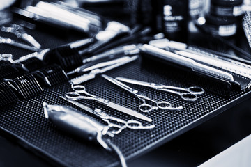 Naklejka premium Professional tools of hairdresser in red case. Tools for cutting beard and hair barbershop.