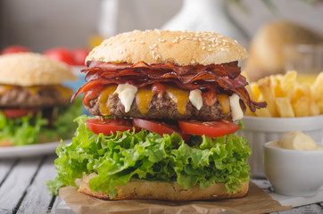 Homemade bacon burger with lettuce and cheddar