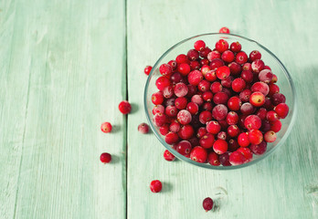 frozen cranberries on wooden surface