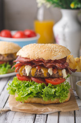 Homemade bacon burger with lettuce and cheddar