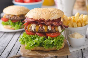 Homemade bacon burger with lettuce and cheddar