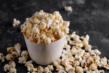 Snack for watching movies. Popcorn bucket on a textural background.