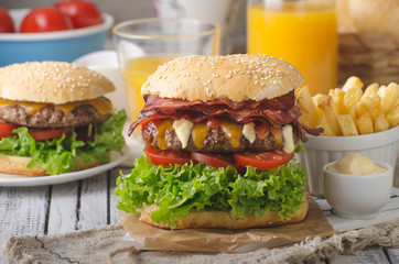 Homemade bacon burger with lettuce and cheddar