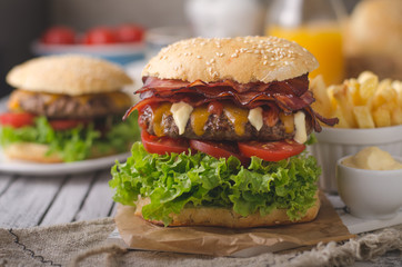Homemade bacon burger with lettuce and cheddar