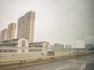 Obraz premium Changsha cityscape view from the bus with the motion of the car on the Highway road.Chang sha city china travel