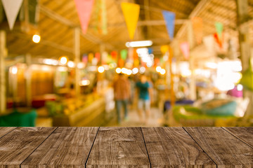 Blur festival background with wooden table top for product display montage.