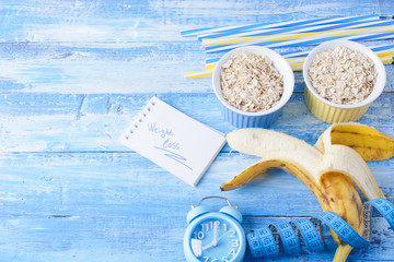 Banana smoothie with honey and oats on a wooden table.
