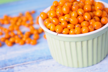 ripe sea buckthorn on a wooden background