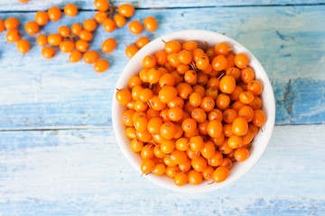 ripe sea buckthorn on a wooden background