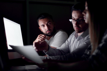 close up.tired employees working overtime.