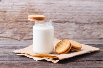 milk with cookies on a wooden background