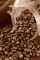 Fototapeta premium Coffee beans in glass jar. Toned photo