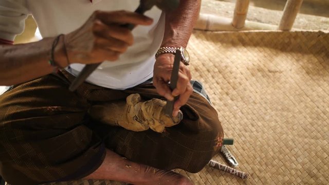 Woodcarver Making Carving with Sharp Tools on Wooden Workpiece. Traditional Balinese Statuette Making Process. 4K. Bali, Indonesia.
