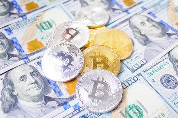 Golden bitcoins on euro,dollar, hryvnia banknotes. Financial background