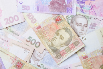 Close up on pile of many bank notes from various countries from around the world. U.S., German, Swiss, Canadian, Brazilian, Vietnamese, Mexican. Many countries represented in currency. 