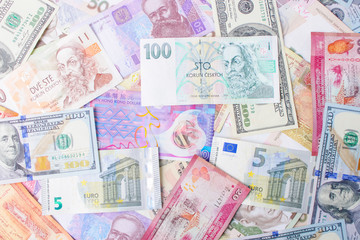 Close up on pile of many bank notes from various countries from around the world. U.S., German, Swiss, Canadian, Brazilian, Vietnamese, Mexican. Many countries represented in currency. 