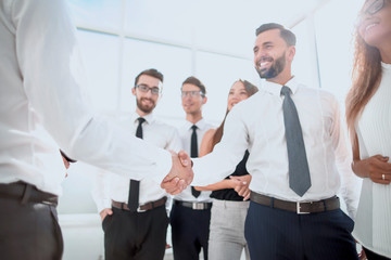 smiling business partners shaking hands