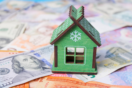 Close up on pile of many bank notes from various countries from around the world. U.S., German, Swiss, Canadian, Brazilian, Vietnamese, Mexican. Many countries represented in currency.