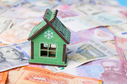 Close up on pile of many bank notes from various countries from around the world. U.S., German, Swiss, Canadian, Brazilian, Vietnamese, Mexican. Many countries represented in currency.