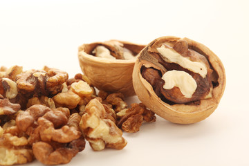 A pile of peeled walnuts at white background