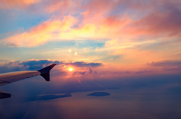 View from airplane window on the wing on sunset time  Plane wing Beautiful colorful sunset