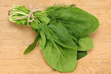 spinach leaves on wooden background. Healthy food. Top view.