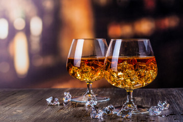 Two glasses of Cognac with ice cubes