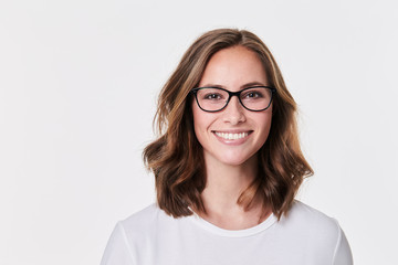 Obraz premium Glasses girl in white t-shirt, smiling