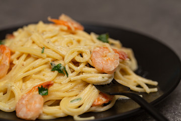 Delicious spaghetti with shrimps, cream sauce and cheese - italian food style