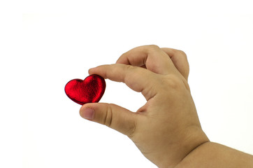 Child's hands with a red heart, isolated