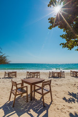 Tables and chairs on the beach at Samet island, Thailand.