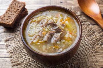 Kharcho soup with meat and rice on wooden table