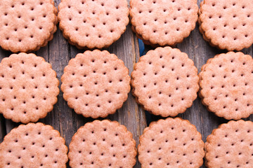cookies with cream filling on wooden background