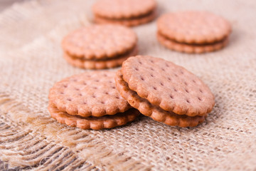 cookies with cream filling on wooden background