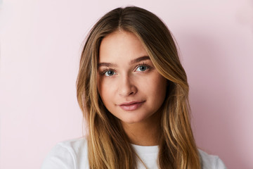 Pretty blond woman against pink background