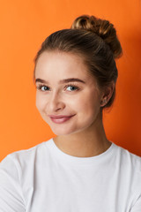 Fototapeta premium Portrait of pretty girl on orange